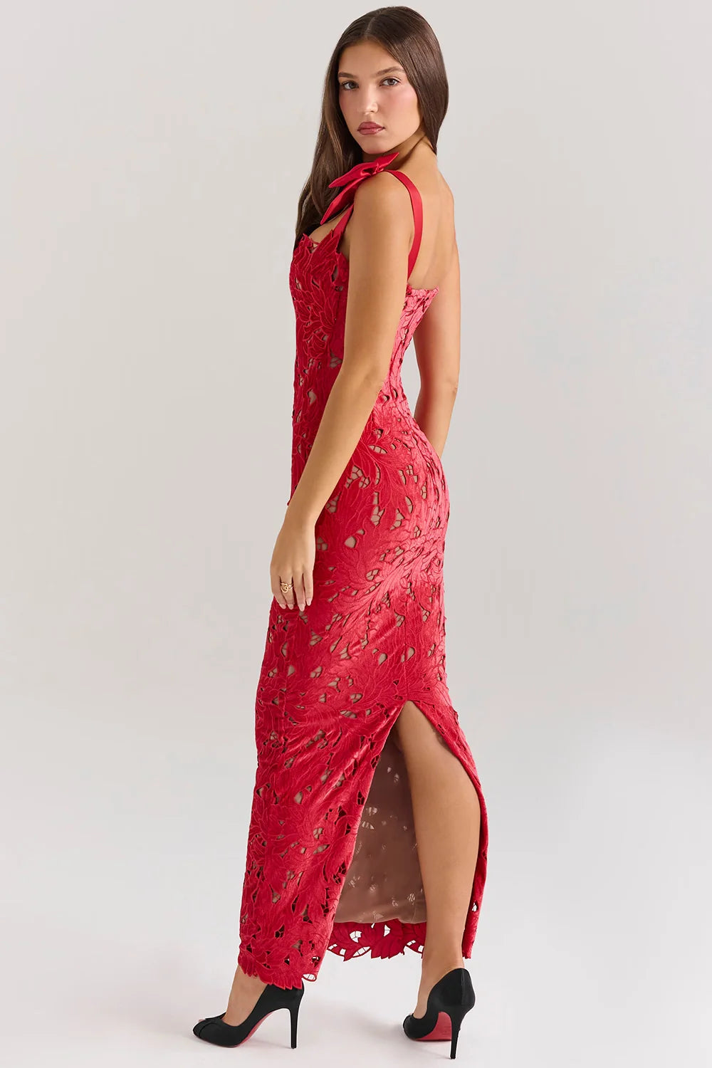 Back view of the Kouvr Fashion Penelope lace gown showing the rear slit and bow strap detail