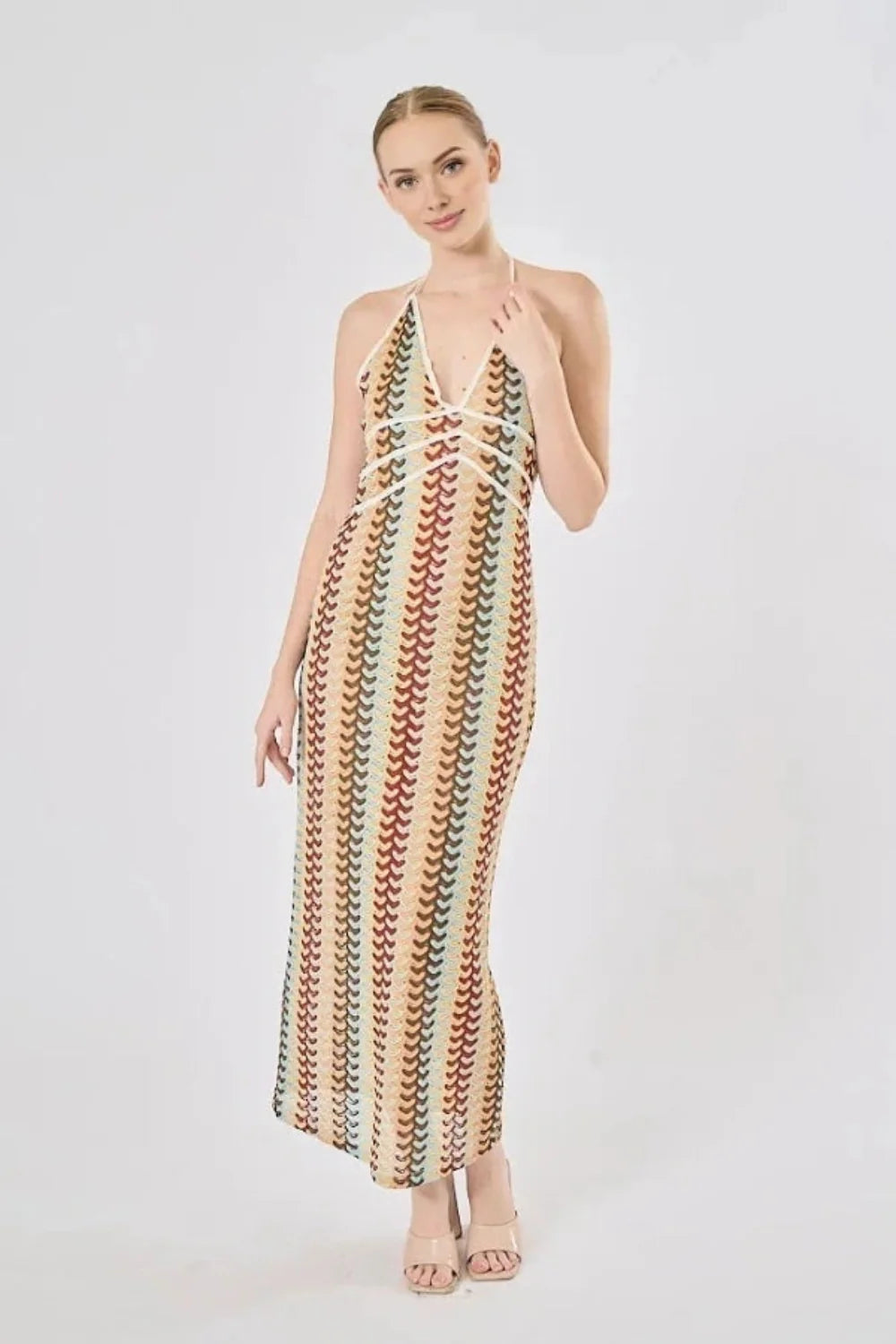 Model viewed from the back wearing the Kouvr Fashion 70s-inspired retro wave print halter maxi dress, showcasing the open-back design