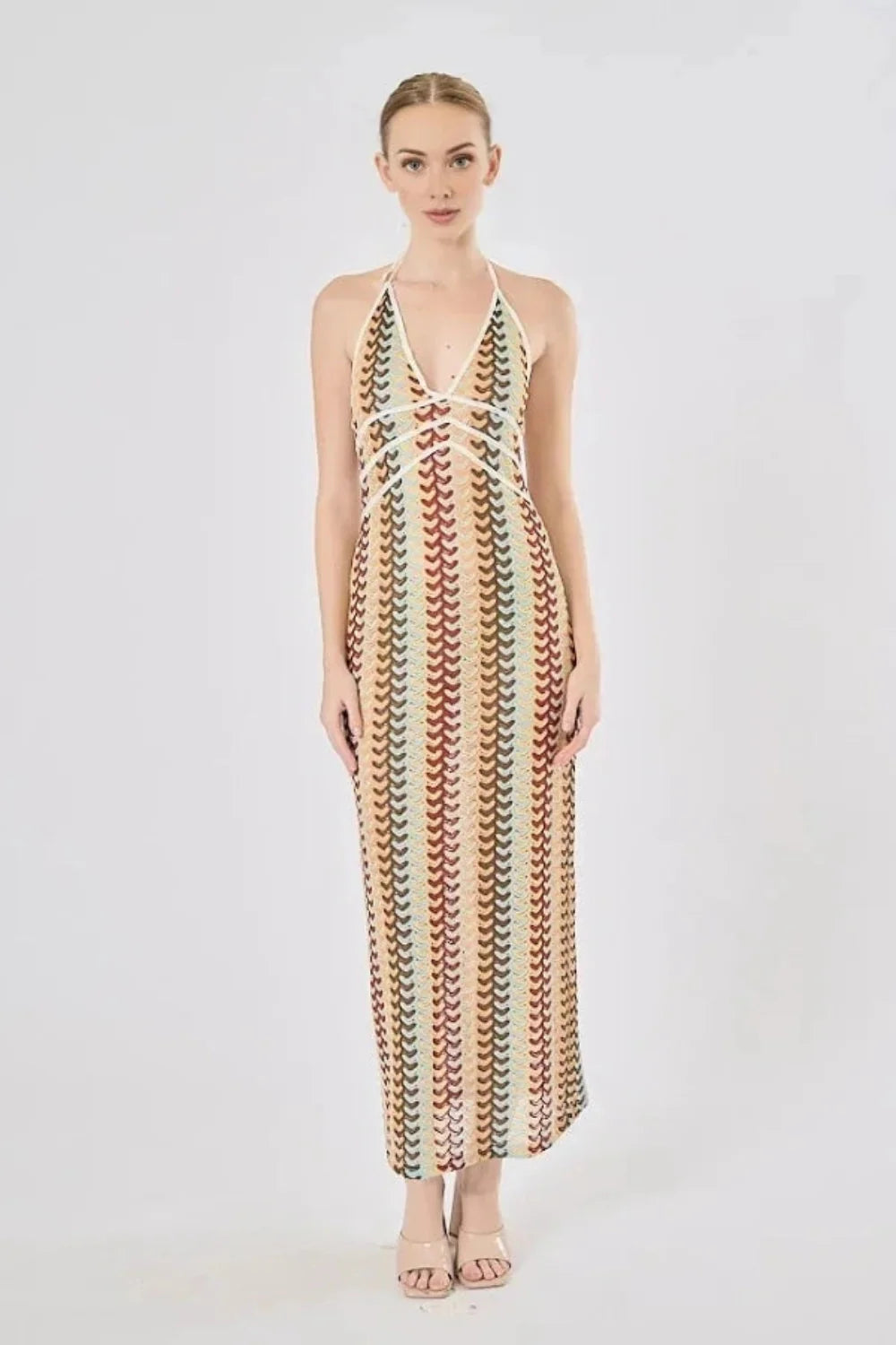 Model viewed from the back wearing the Kouvr Fashion 70s-inspired retro wave print halter maxi dress, showcasing the open-back design