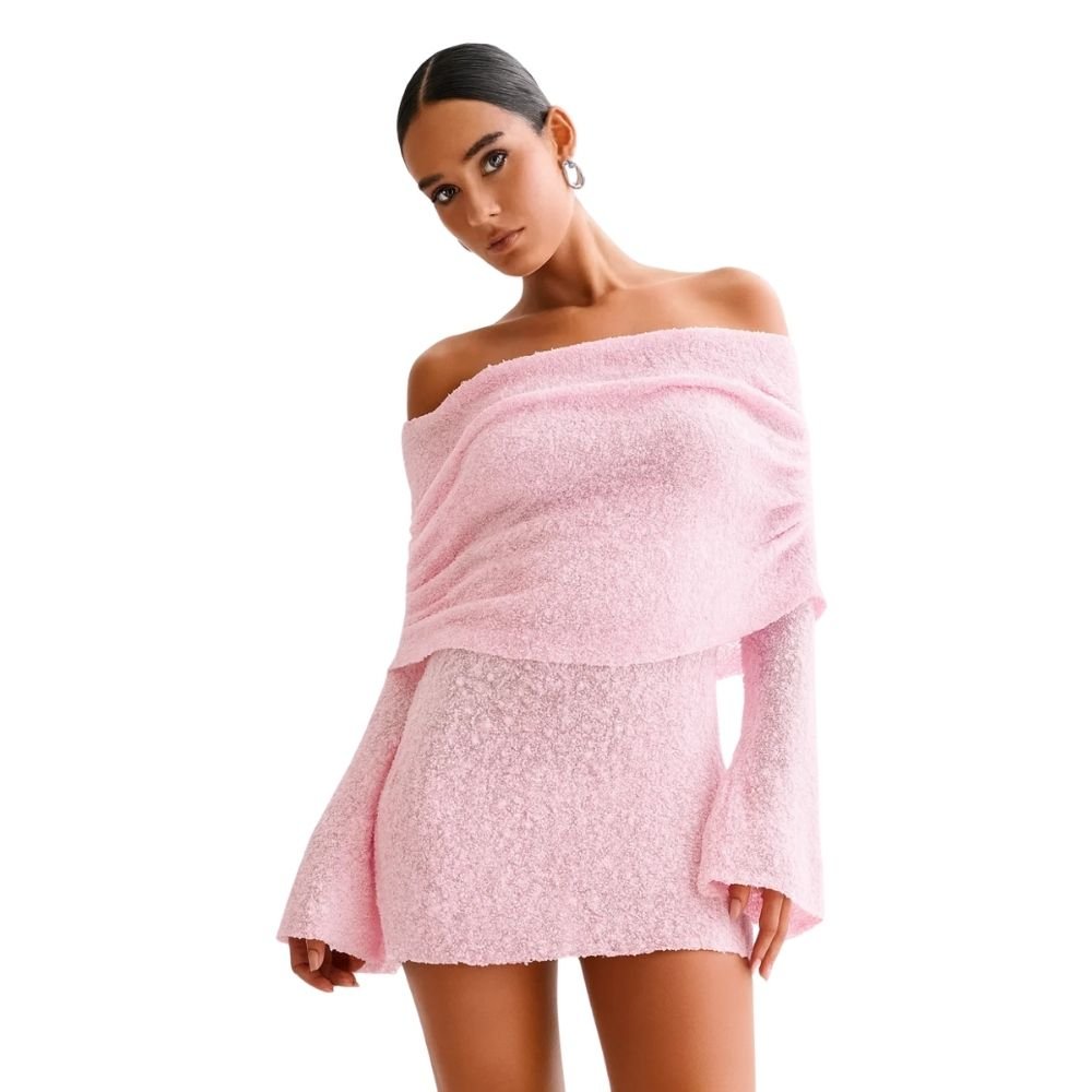 Woman wearing a pink kouvr off-shoulder top and skirt set on a white background