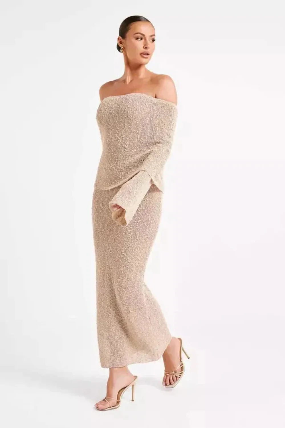 Model wearing the Kouvr Selah off-shoulder knit maxi dress in beige sand