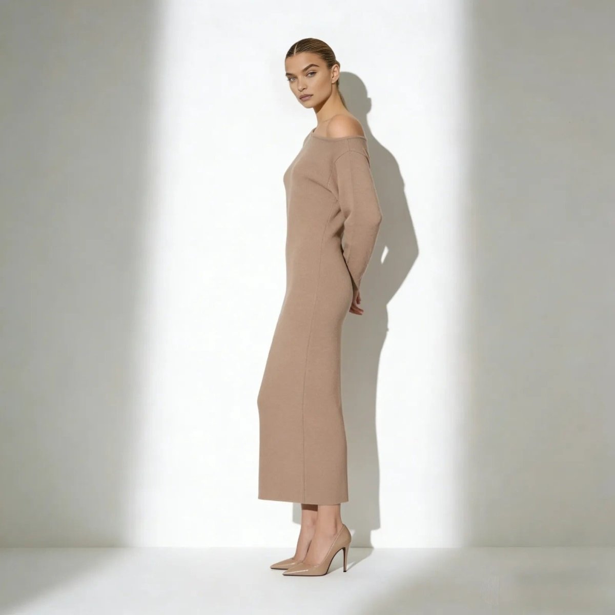 Model wearing the Kouvr Fashion Selena one-shoulder long sleeve knit midi dress in camel, side profile view.