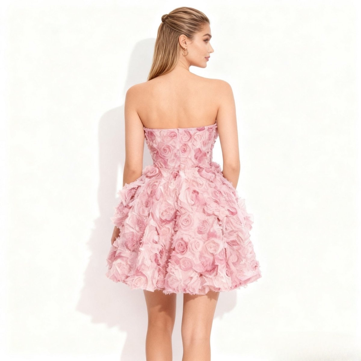Back view of the Kouvr Fashion strapless pink rosette dress showing the concealed zipper.