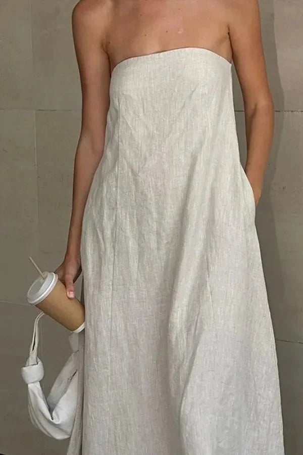 Model from behind wearing the Kouvr Fashion strapless linen maxi dress showing the smocked back detail