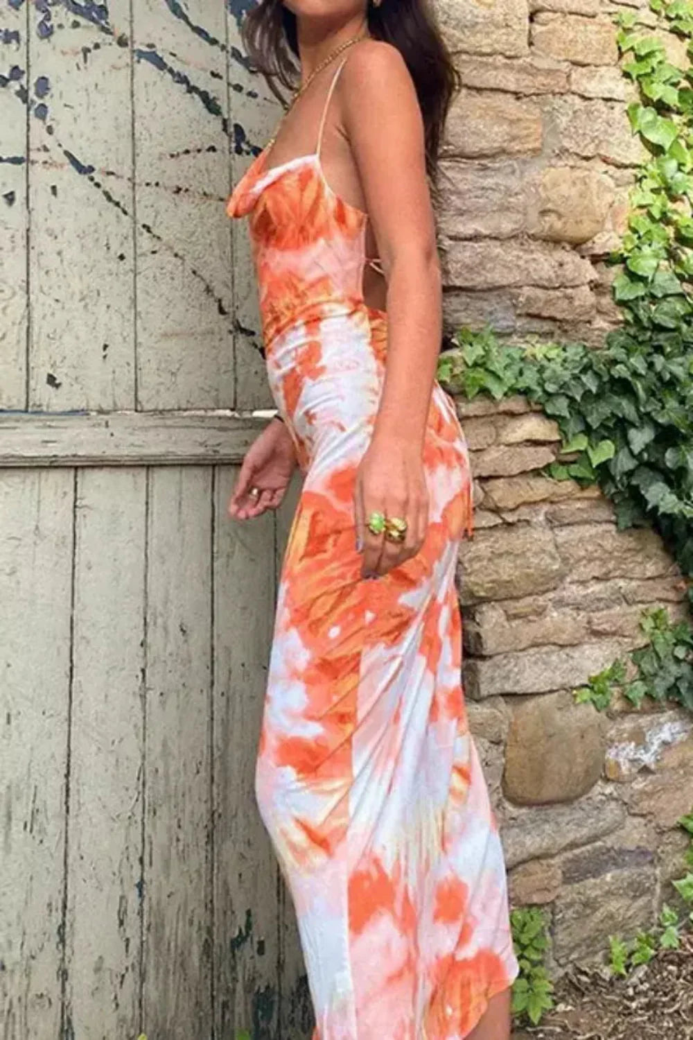 Model wearing the Kouvr Fashion Sunset Orange Tie-Dye Slip Dress with backless lace-up detail
