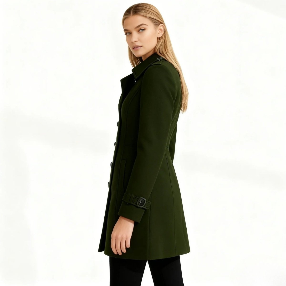 Woman wearing a green Kouvr coat on a white background