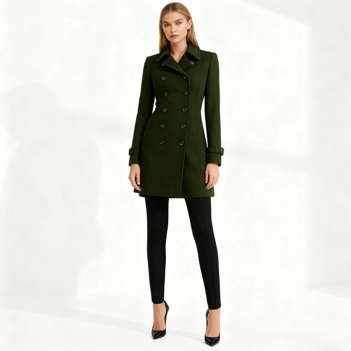 Woman wearing a green Kouvr coat on a white background