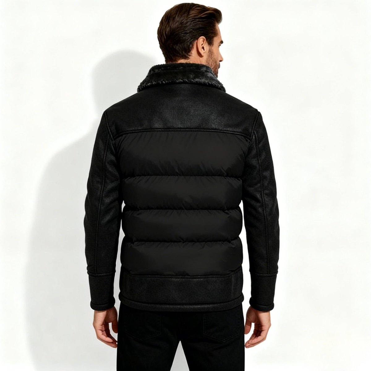 Man wearing a black Kouvr puffer jacket with fur collar on a white background