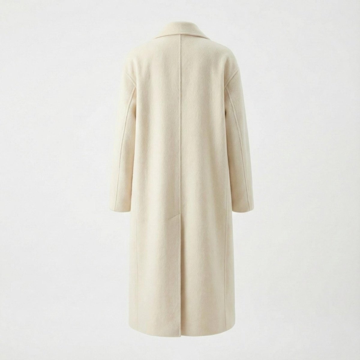 Flat lay of the back of the Kouvr Fashion Maddie ivory wool coat, detailing the clean lines and minimalist construction.