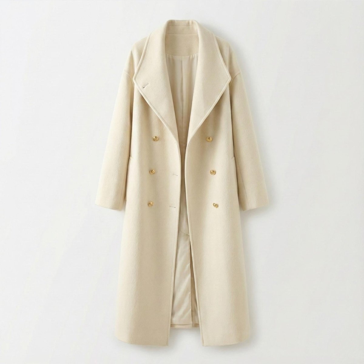 Flat lay product shot of the Kouvr Fashion Maddie double-breasted coat in ivory, displayed open to show the gold buttons and interior lining.