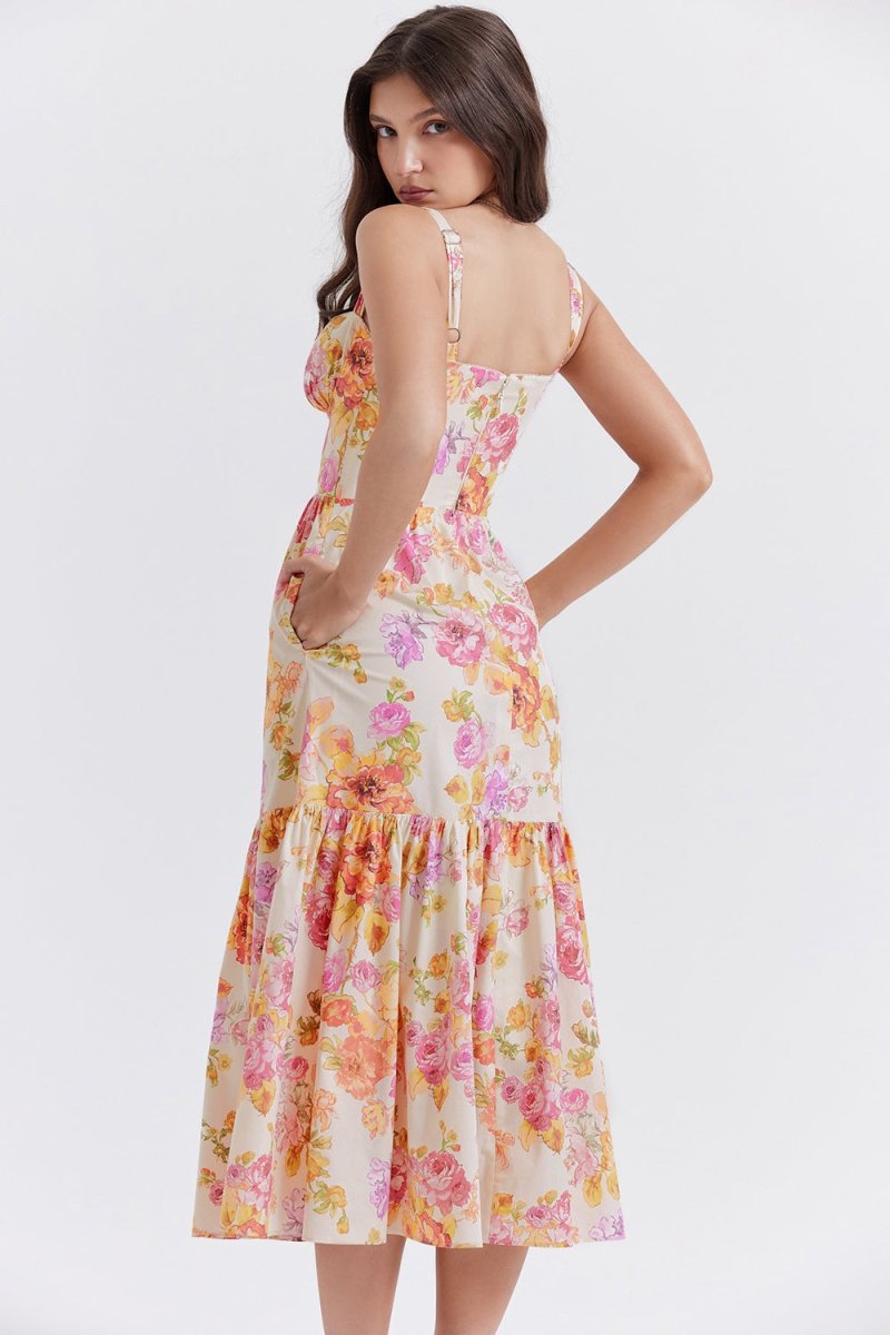 Back view of The Persephone floral bustier midi dress, showing the adjustable straps and smocked back panel detail.