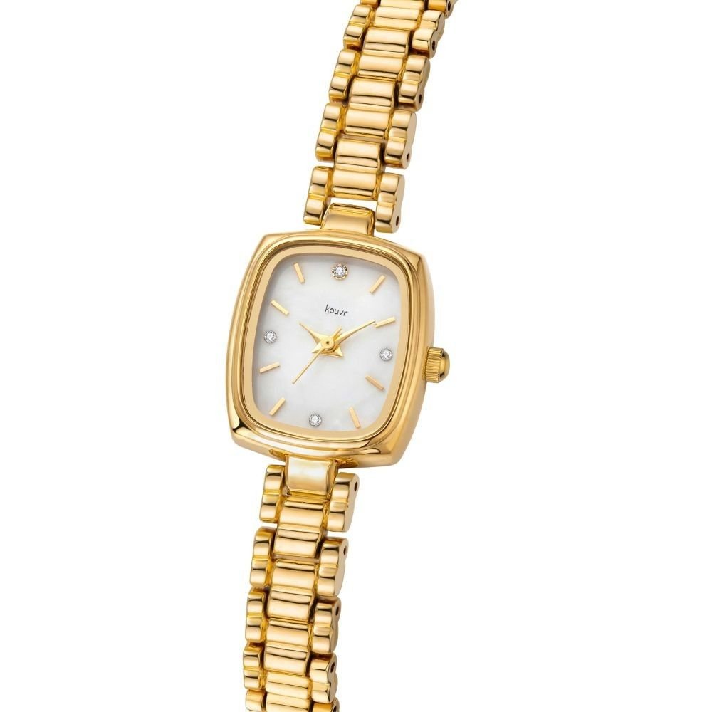 Gold Kouvr wristwatch with a white face on a wrist, against a neutral background