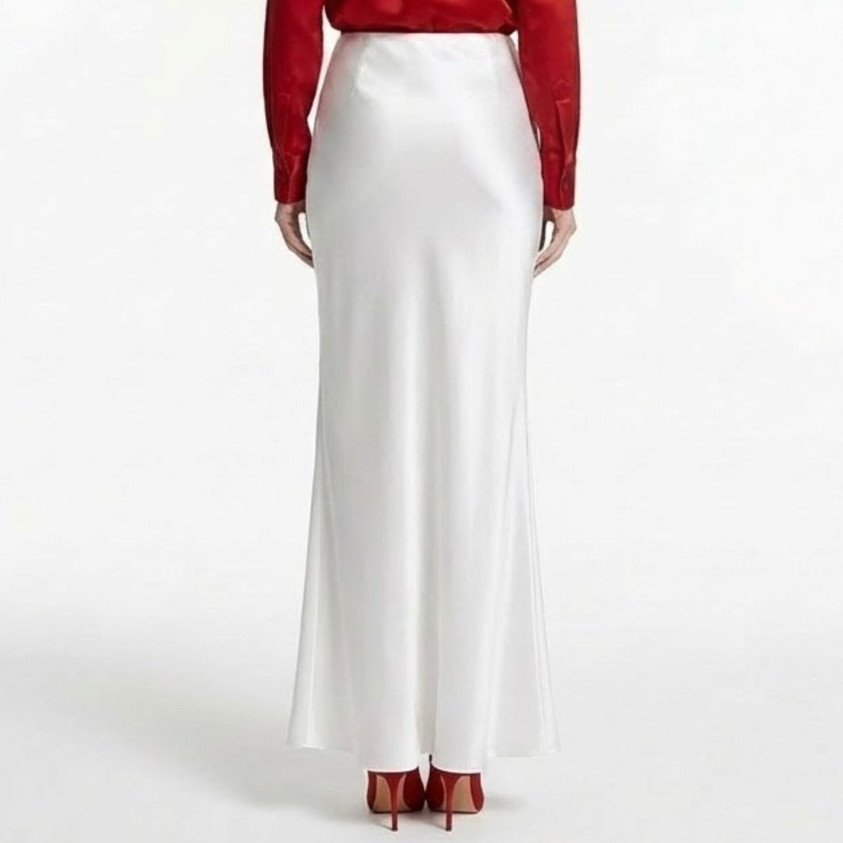 Studio product shot of the Kouvr Fashion ivory white silk bias cut maxi skirt on a white background.