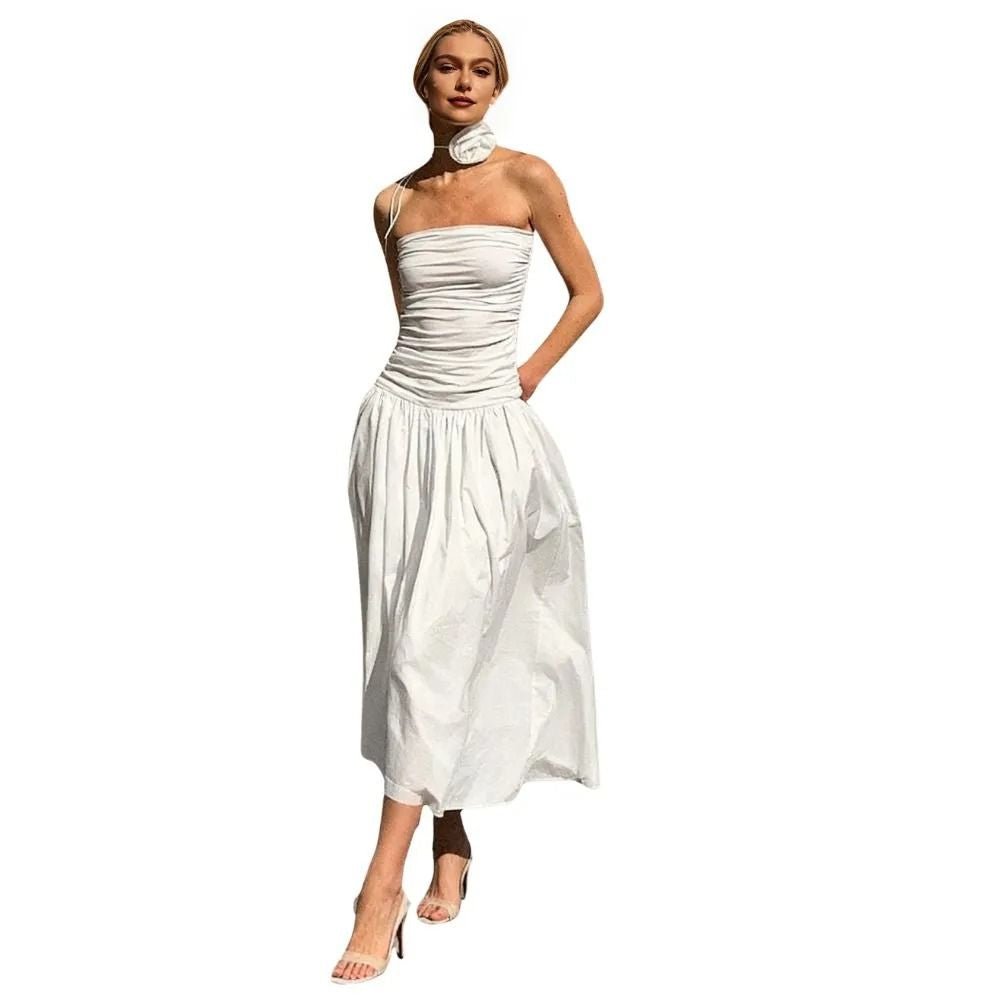 Woman wearing a white kouvr strapless dress on a white background