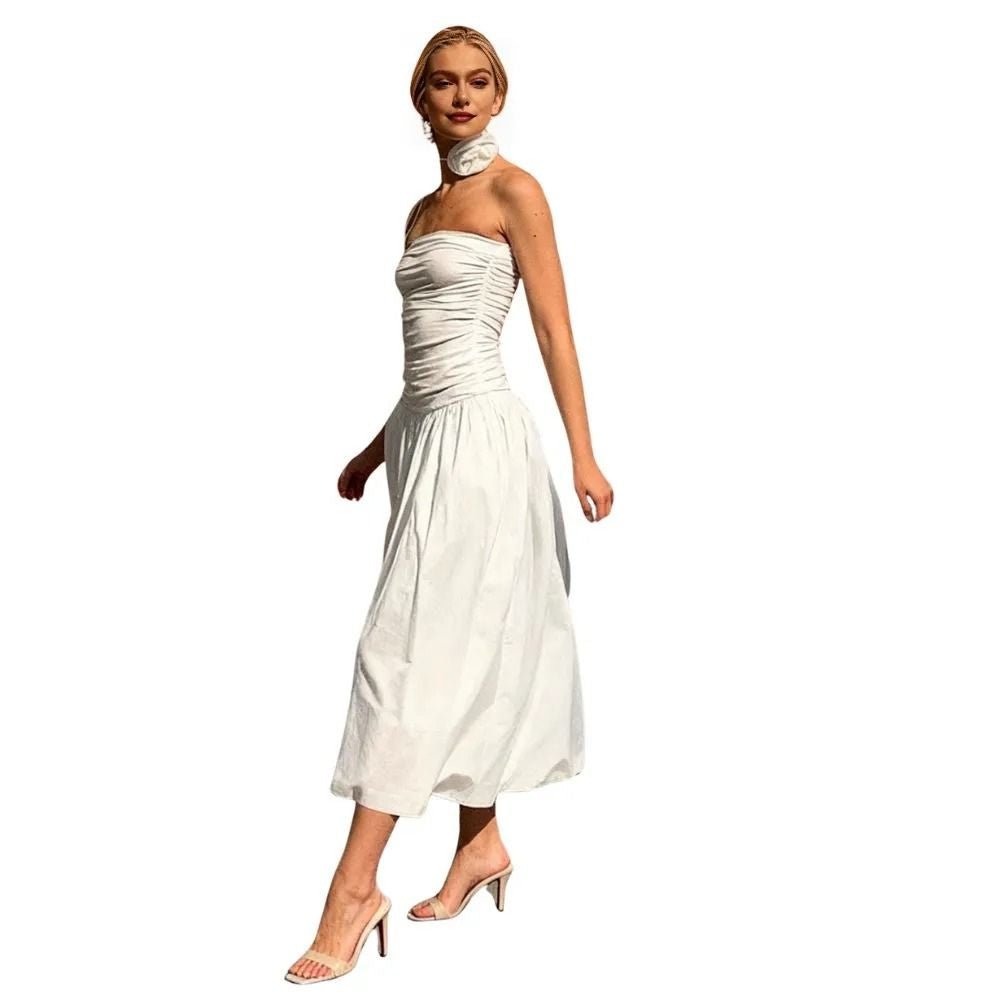Woman wearing a white kouvr strapless dress on a white background