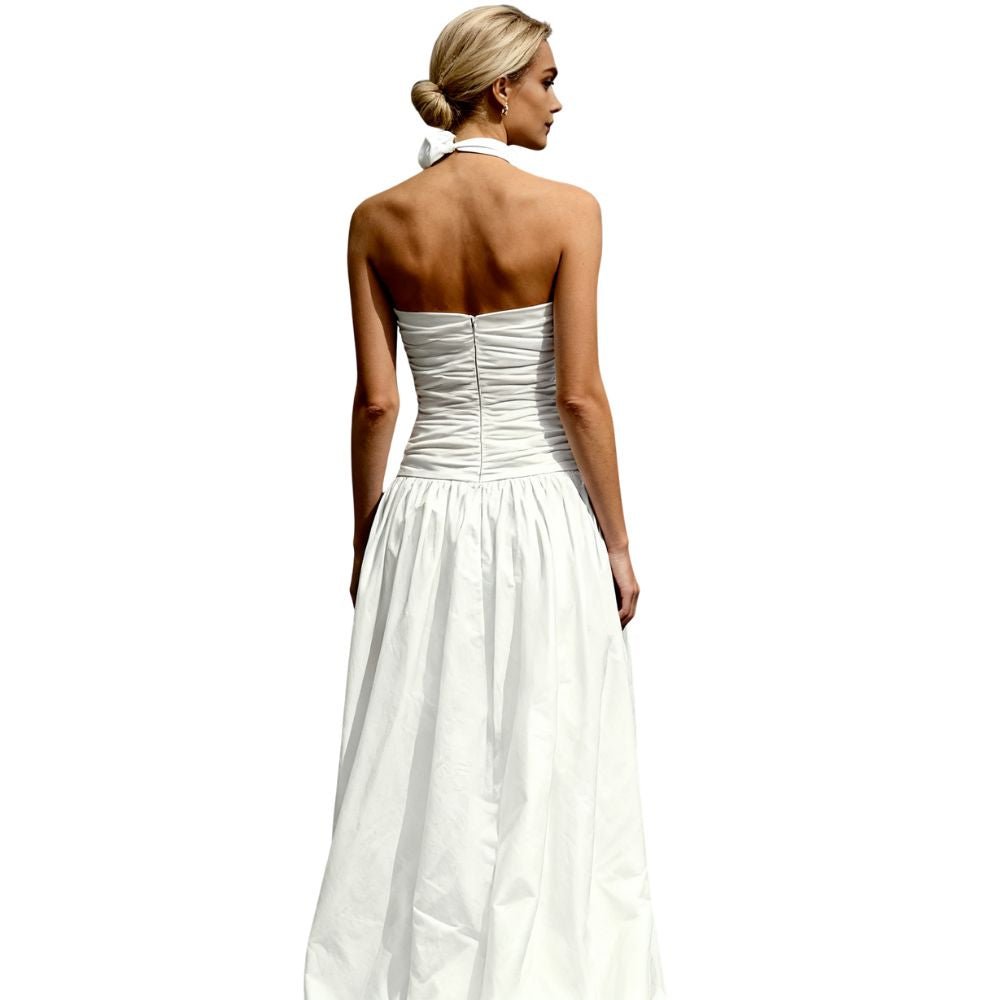 Woman wearing a white kouvr strapless gown on a white background