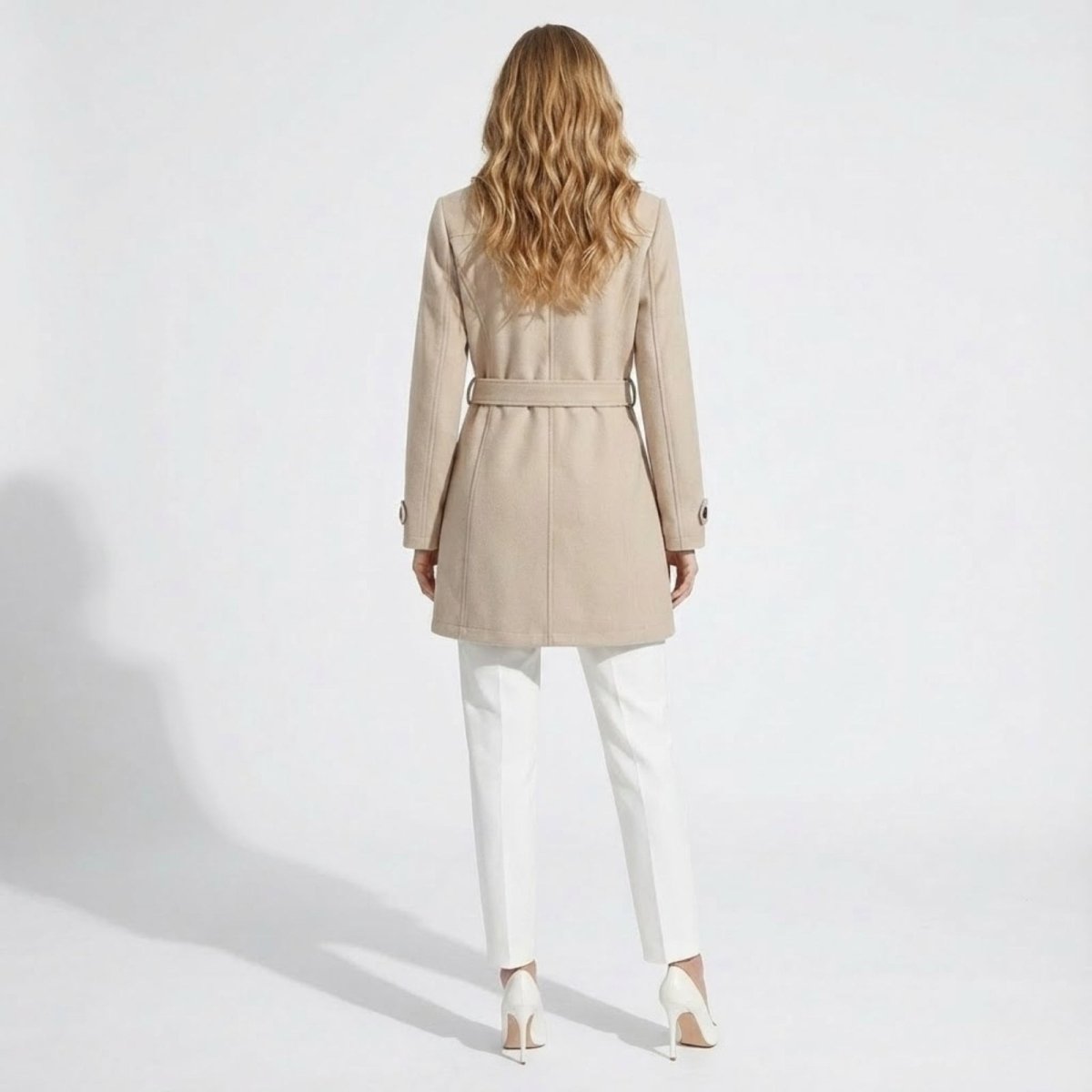 Back view of the Kouvr Fashion women's beige wool coat, highlighting the belted waist and clean seam lines.
