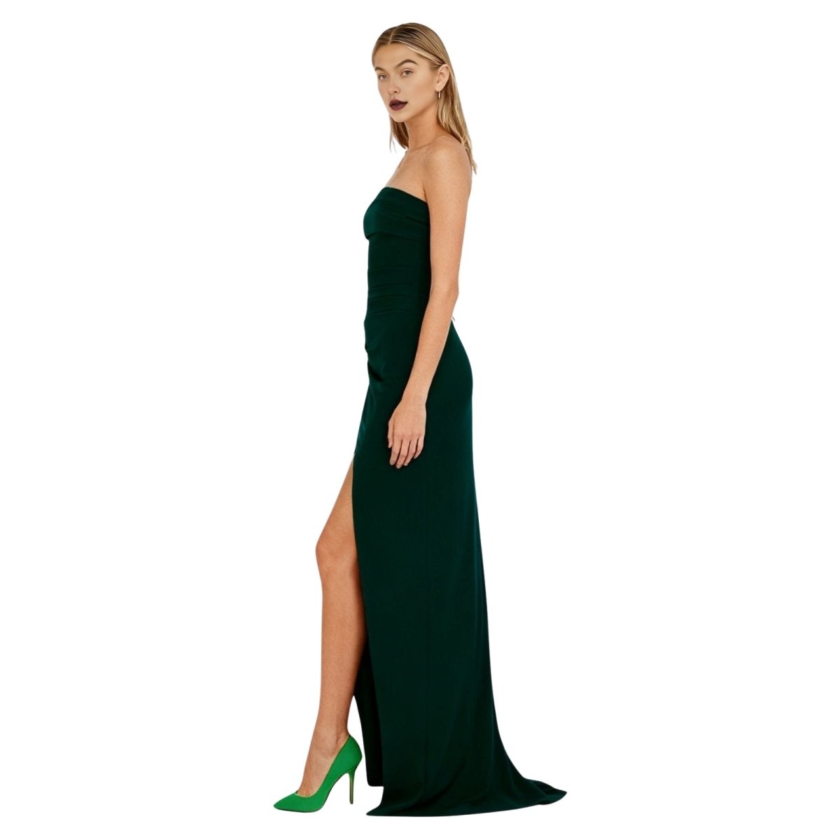 Woman wearing a green kouvr  strapless gown with a high slit on a white background