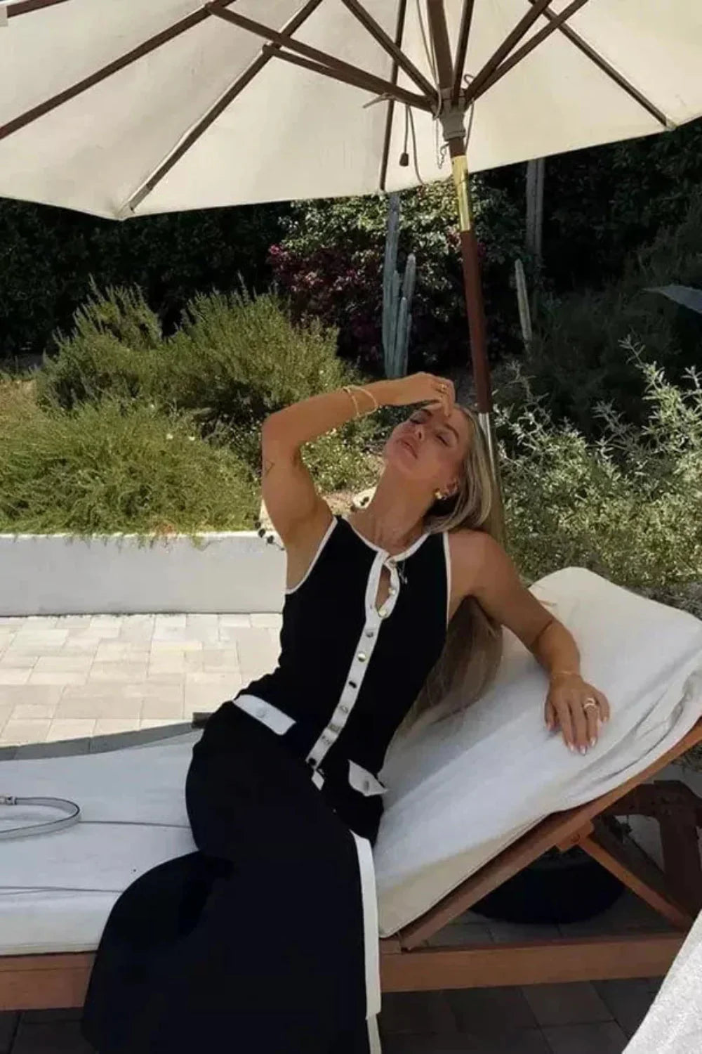 Kouvr Fashion Fiorella Knit Midi Dress in black worn by a model on a city street