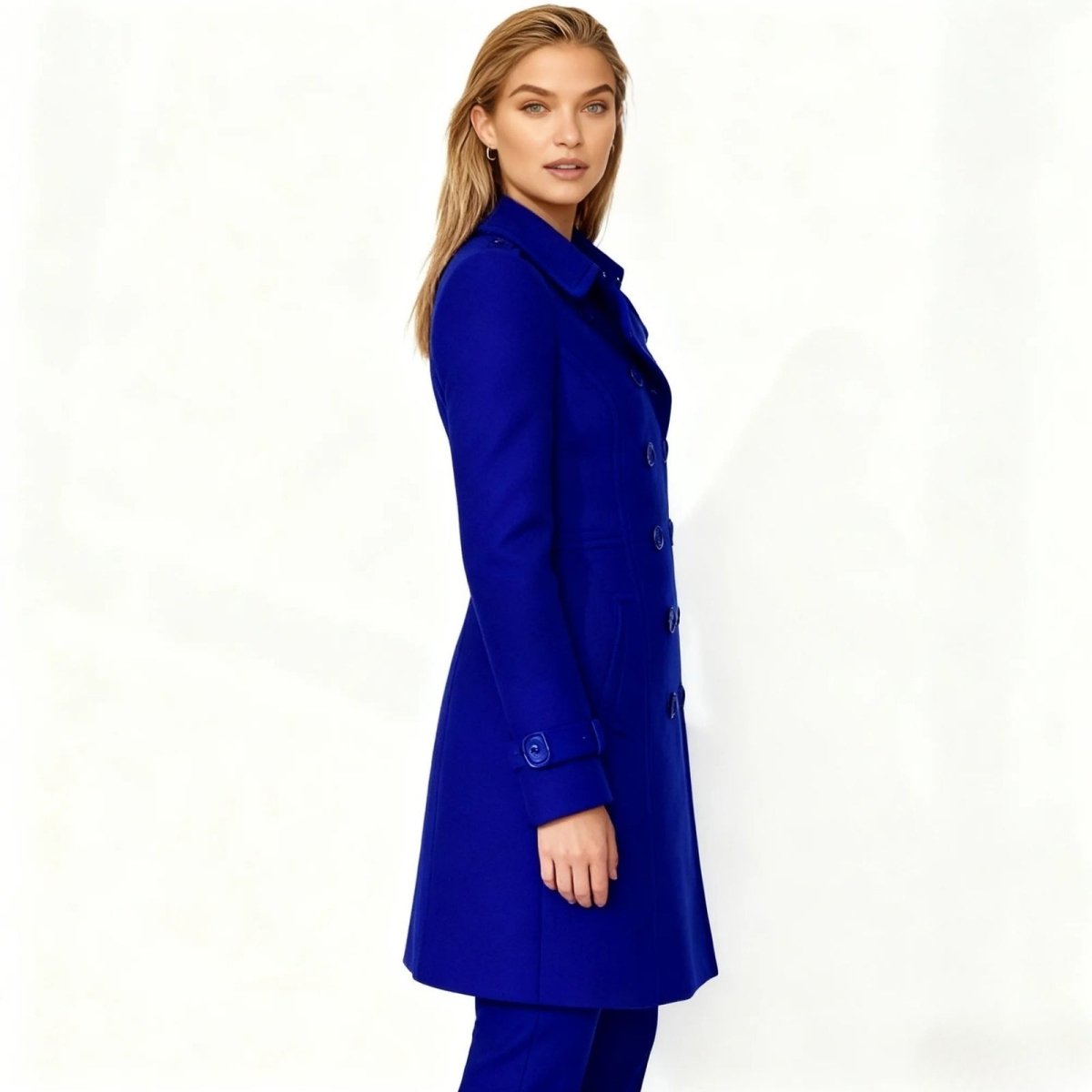 Woman wearing a blue Kouvr coat on a white background