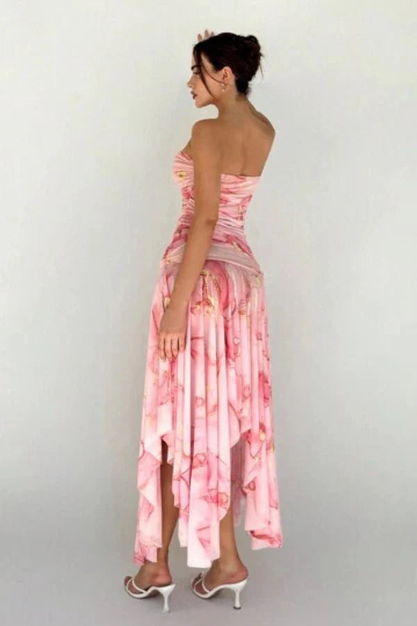 Model wearing the Kouvr Floretta pink floral ruched strapless dress with an asymmetrical chiffon skirt
