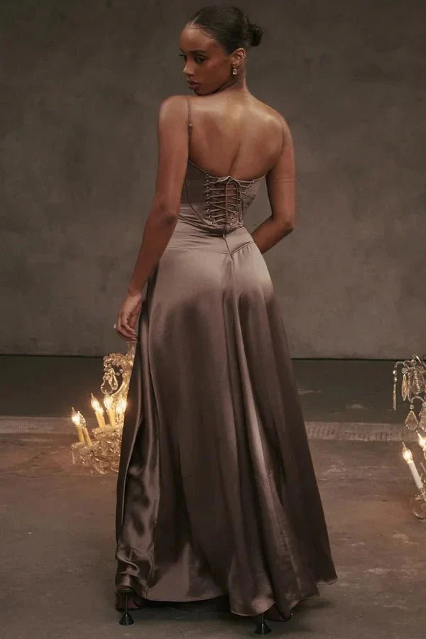 Kouvr Gabriella Gown in Mocha: a brown satin corset maxi dress with a lace-up back, worn by a model.