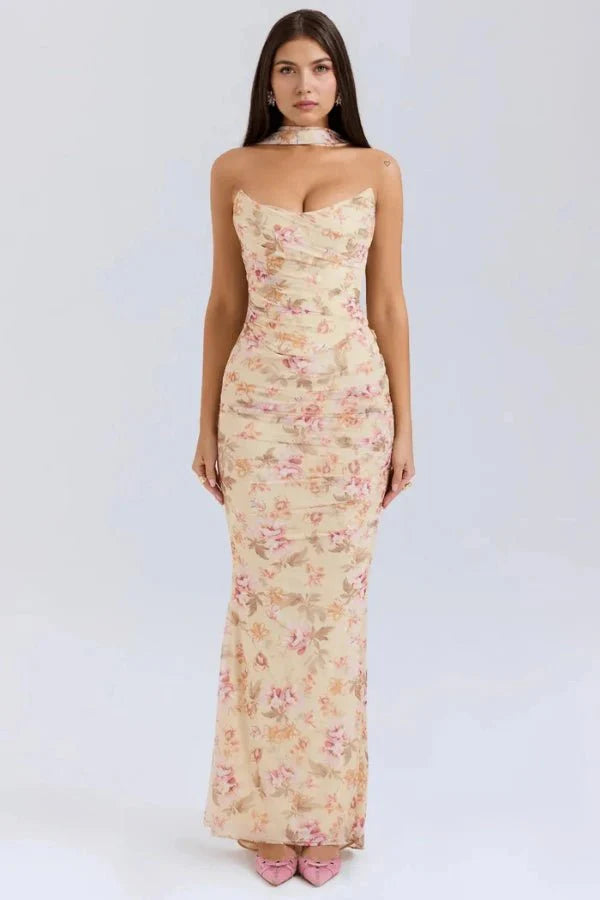 Model wearing Kouvr Hailey yellow floral strapless maxi dress with draped bodice and scarf detail, front view