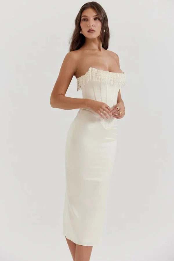 Model wearing Kouvr ivory satin strapless corset dress with pearl fringe