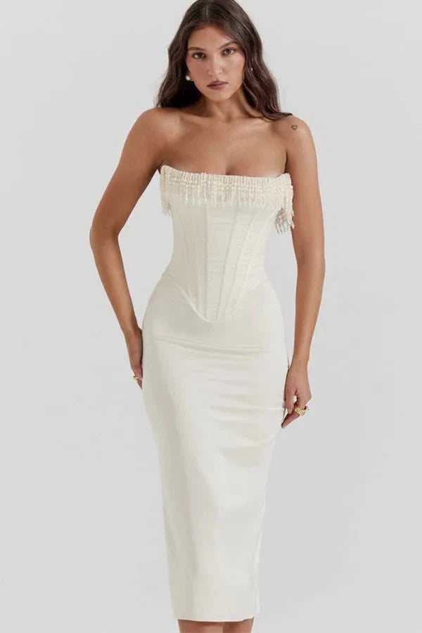Model wearing Kouvr ivory satin strapless corset dress with pearl fringe