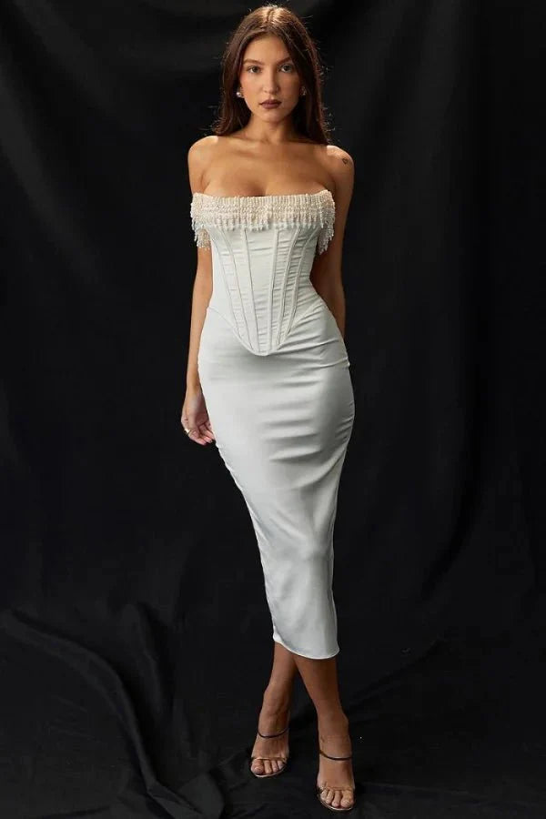Model wearing Kouvr ivory satin strapless corset dress with pearl fringe