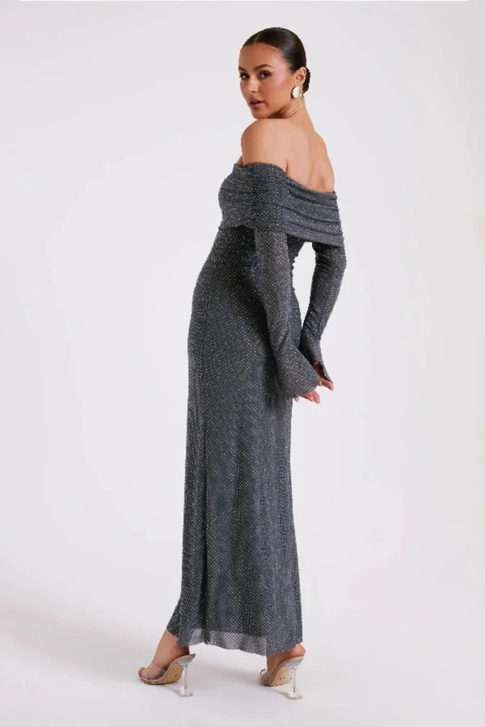 Model wearing Kouvr Jada long sleeve off-the-shoulder evening gown in gray
