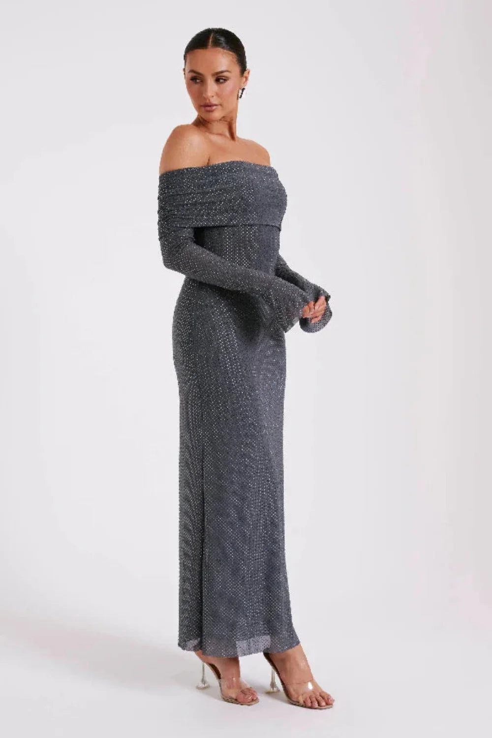 Model wearing Kouvr Jada long sleeve off-the-shoulder evening gown in gray