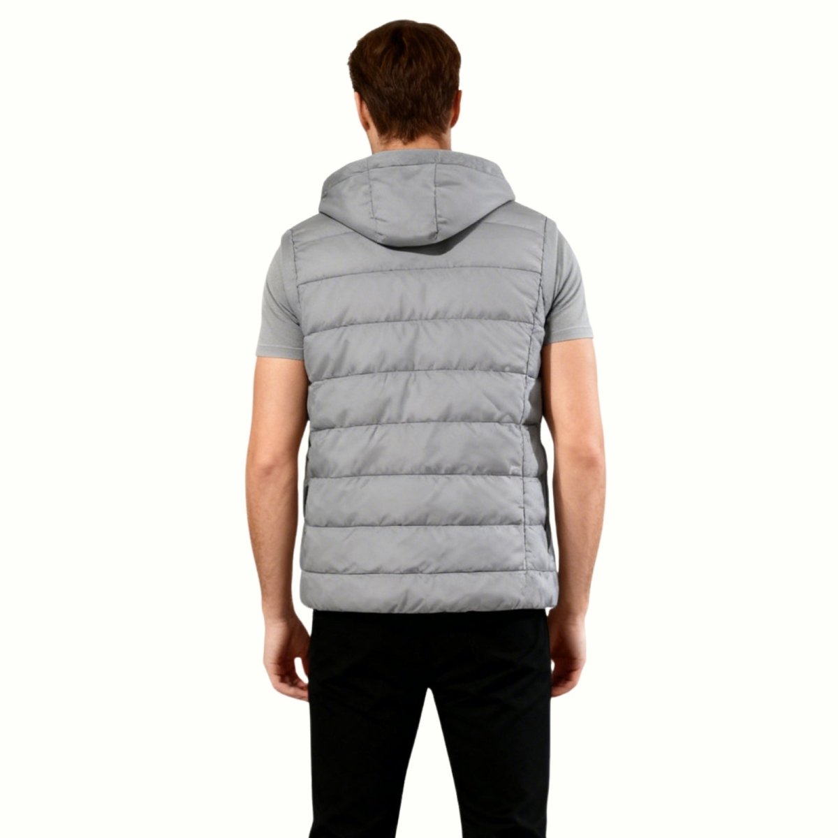 Back view of a male model wearing the grey Kouvr sleeveless puffer jacket, displaying the horizontal quilting and fit of the hood.
