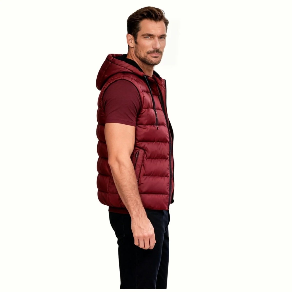 Angled view of the Kouvr Jomari Puffer Vest, highlighting the hood construction, black drawstrings, and quilted texture. 