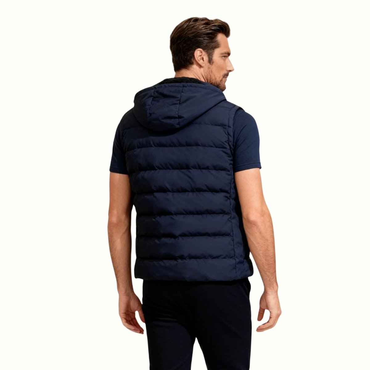 Back view of the Kouvr Jomari men's navy insulated sleeveless jacket, displaying the horizontal quilting and hood.