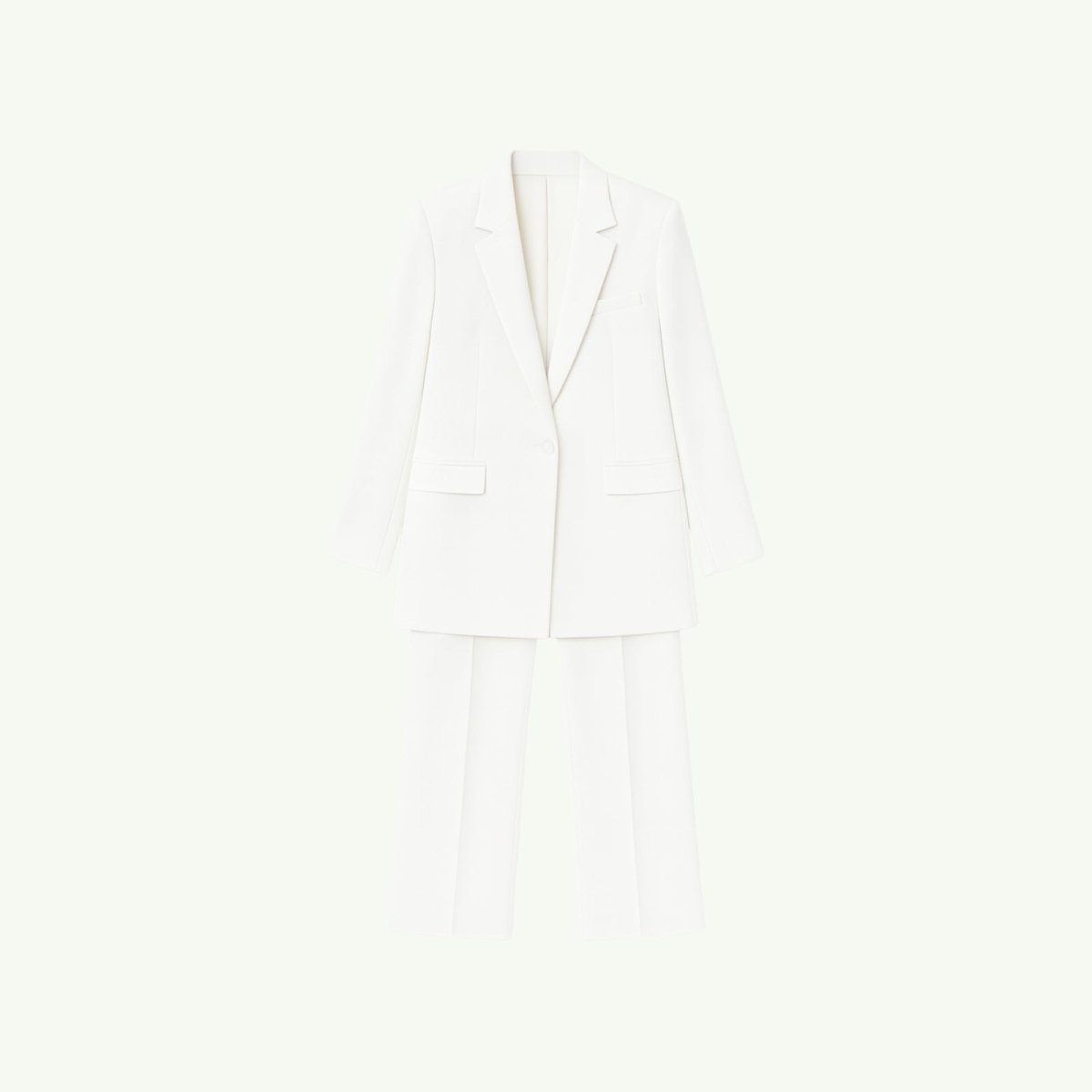 Flatlay of the Kouvr Kate white blazer and matching trousers, showing the sharp peak lapels, flap pockets, and pressed crease on the pants.