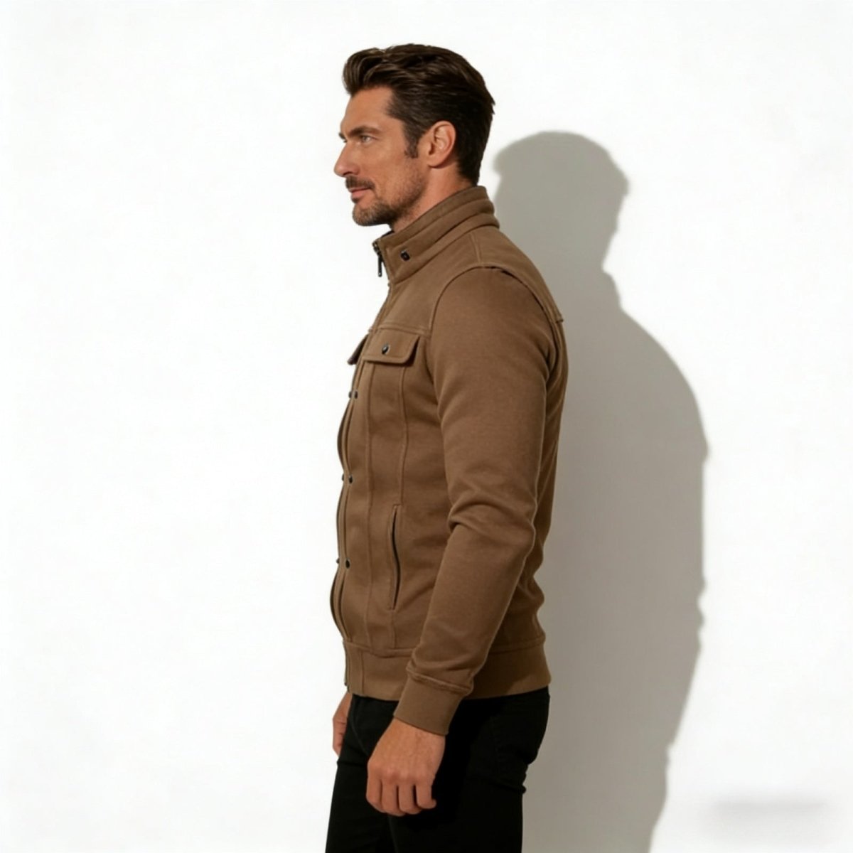 Side profile of a male model wearing the Kouvr Kent stand collar jacket in brown, showing the jacket's slim fit and silhouette.