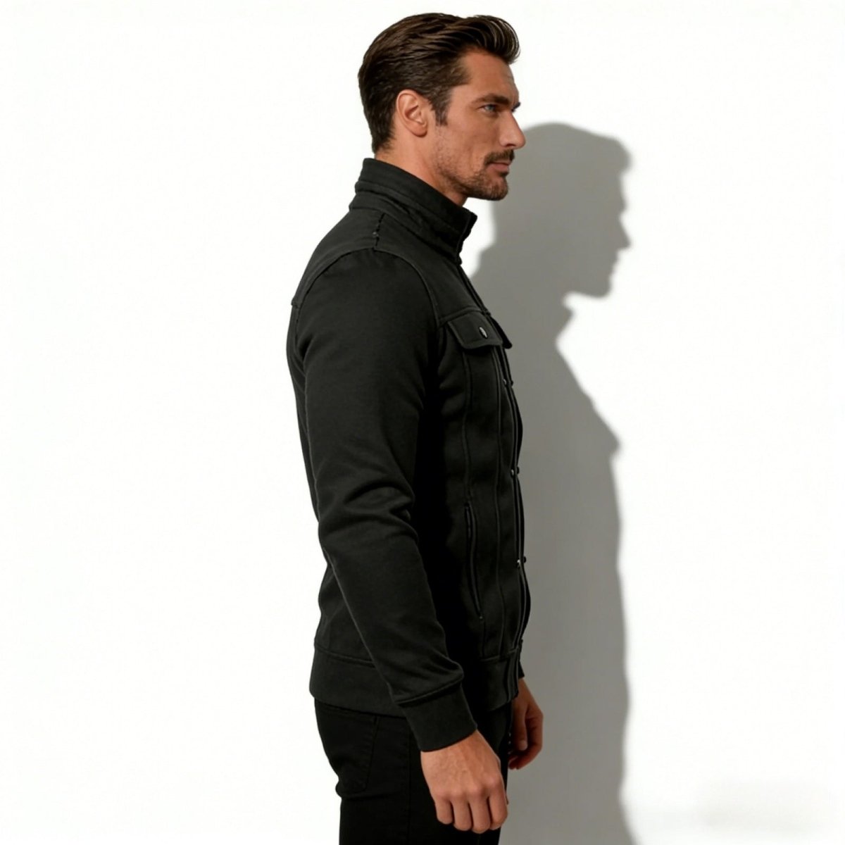 Side profile of a man in a Kouvr Kent black structured knit jacket, showing the slim fit and tailored silhouette.