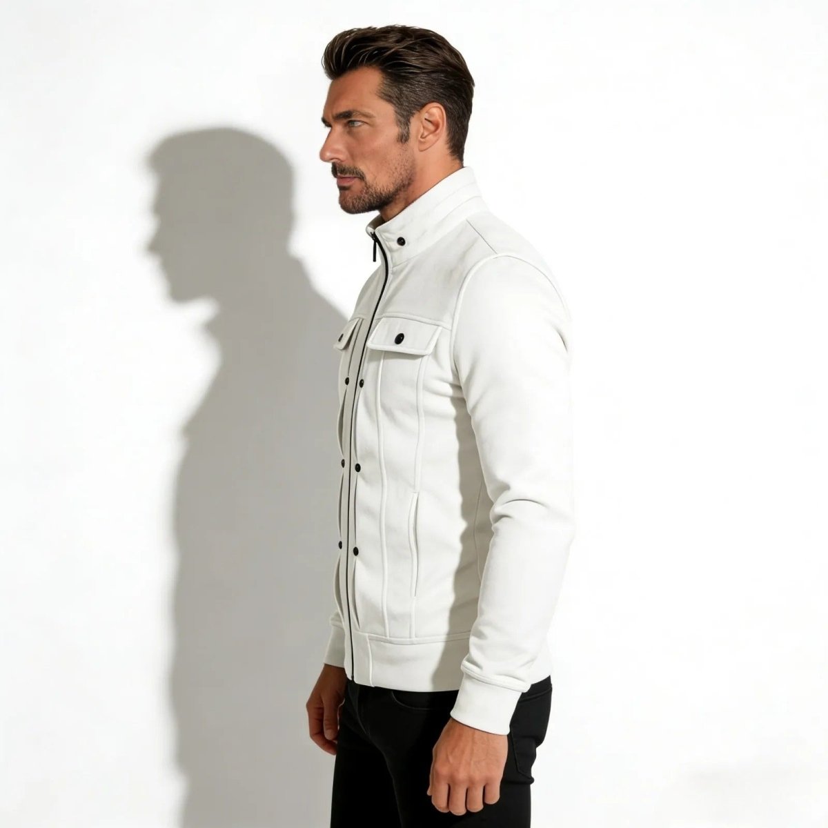 Side profile of a man wearing the Kouvr Kent white technical jacket, showing its tailored fit and sleeve construction.