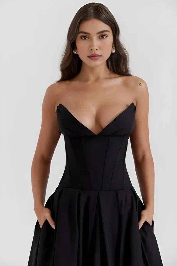 Model wearing Kouvr Fashion's black strapless corset midi dress for a formal event