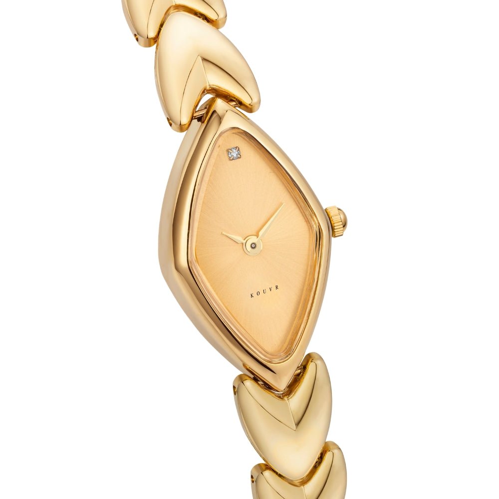 Gold Kouvr watch with a diamond on a white background