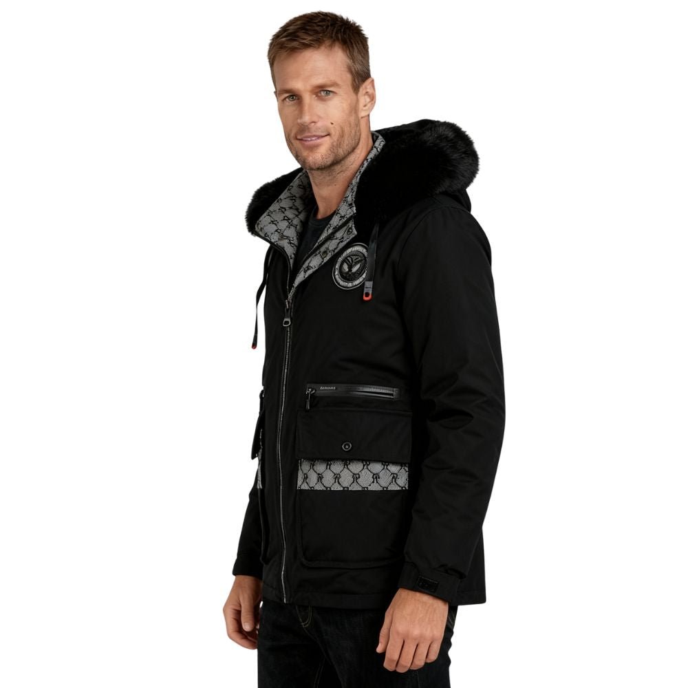 Man wearing a black kouvr jacket with patterned interior on a white background