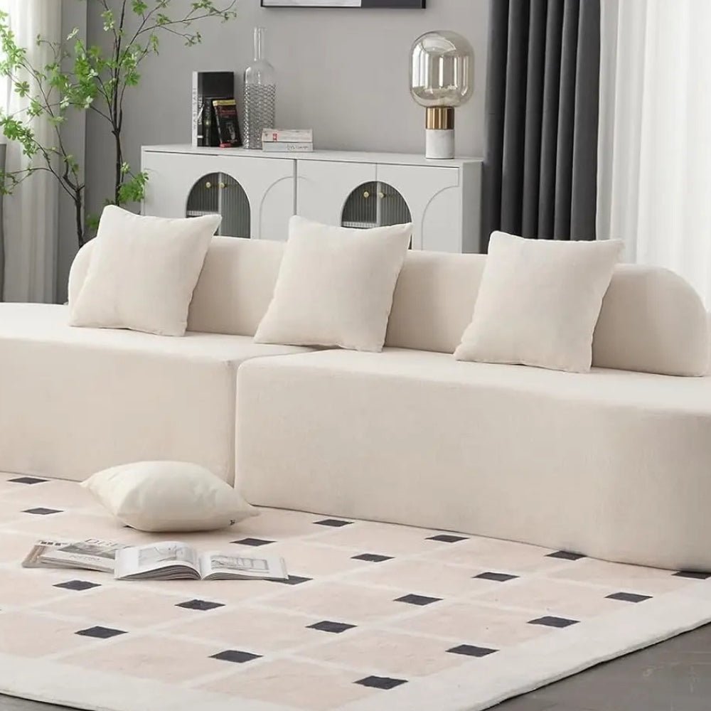 luxe couch," "minimalist sofa," "low-profile sectional," "bouclé fabric sofa," "cloud sofa alternative," and "statement living room furniture