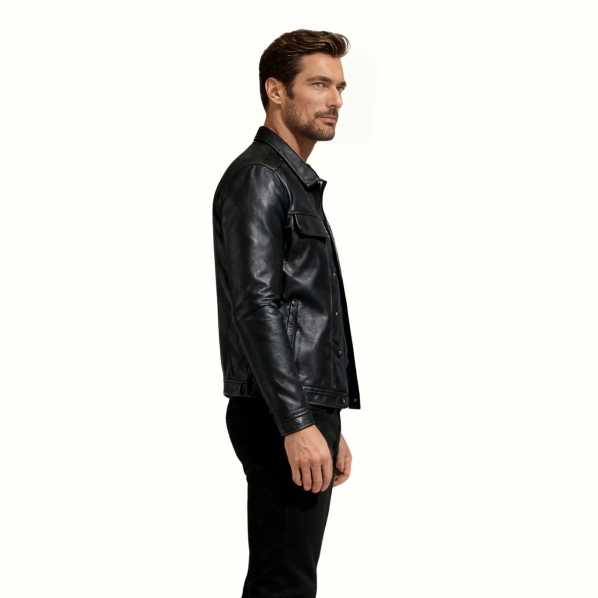 Side profile of a man wearing the Kouvr clinton black leather jacket, highlighting its slim fit and sleeve length.