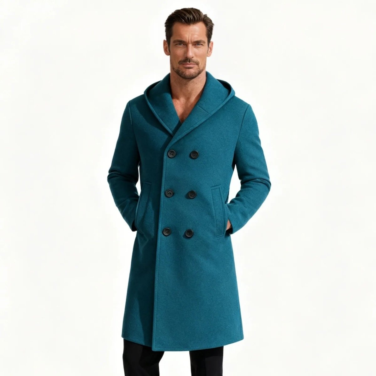 A man wearing the Kouvr Azure Blue Hooded Wool Overcoat, showing the full front view with its double-breasted design and asymmetrical hem.