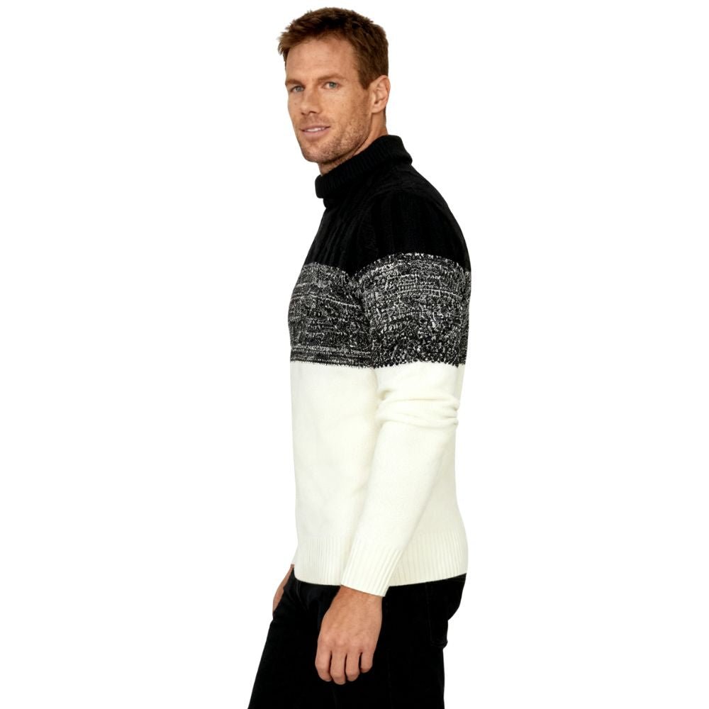 A man wearing the Kouvr color block turtleneck sweater in black, textured grey, and cream, paired with black trousers.