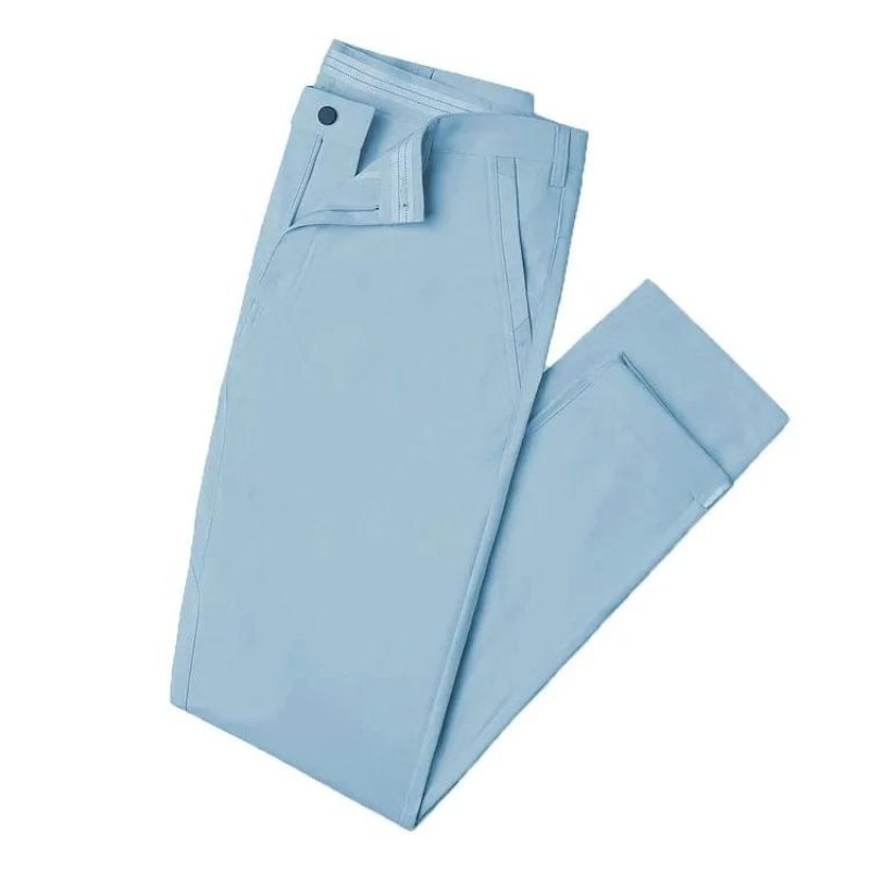 Neatly folded Kouvr All-Day Commuter Pants in a bright sky blue color, displaying the pant's clean construction and color vibrancy.