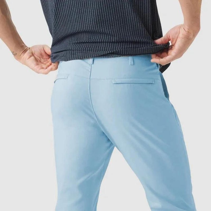 Neatly folded Kouvr All-Day Commuter Pants in a bright sky blue color, displaying the pant's clean construction and color vibrancy.
