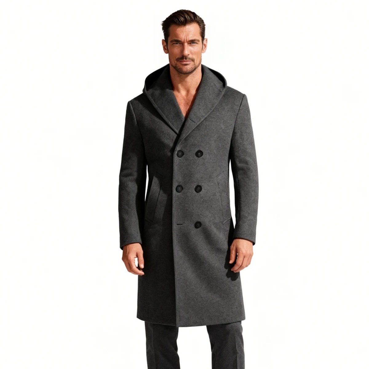 A man wearing the Kouvr Fashion black hooded double-breasted wool overcoat with a slim fit.