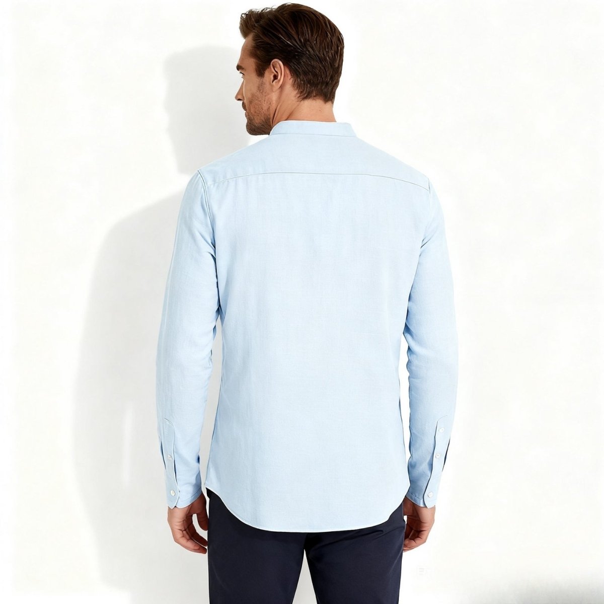 Back view of the Kouvr men's light blue linen summer shirt, displaying the clean back yoke and overall fit.
